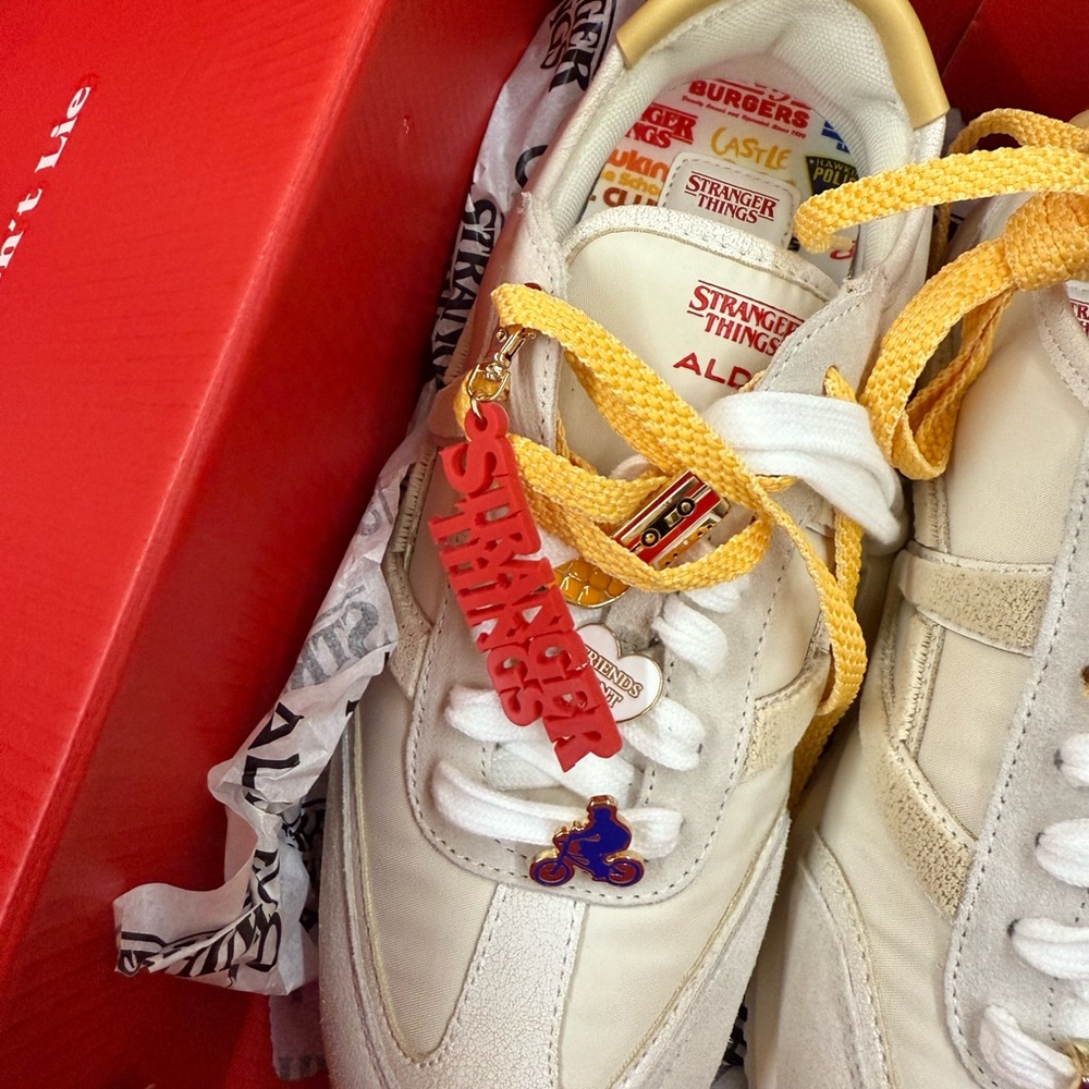Aldo cream sneakers with yellow laces and red charm